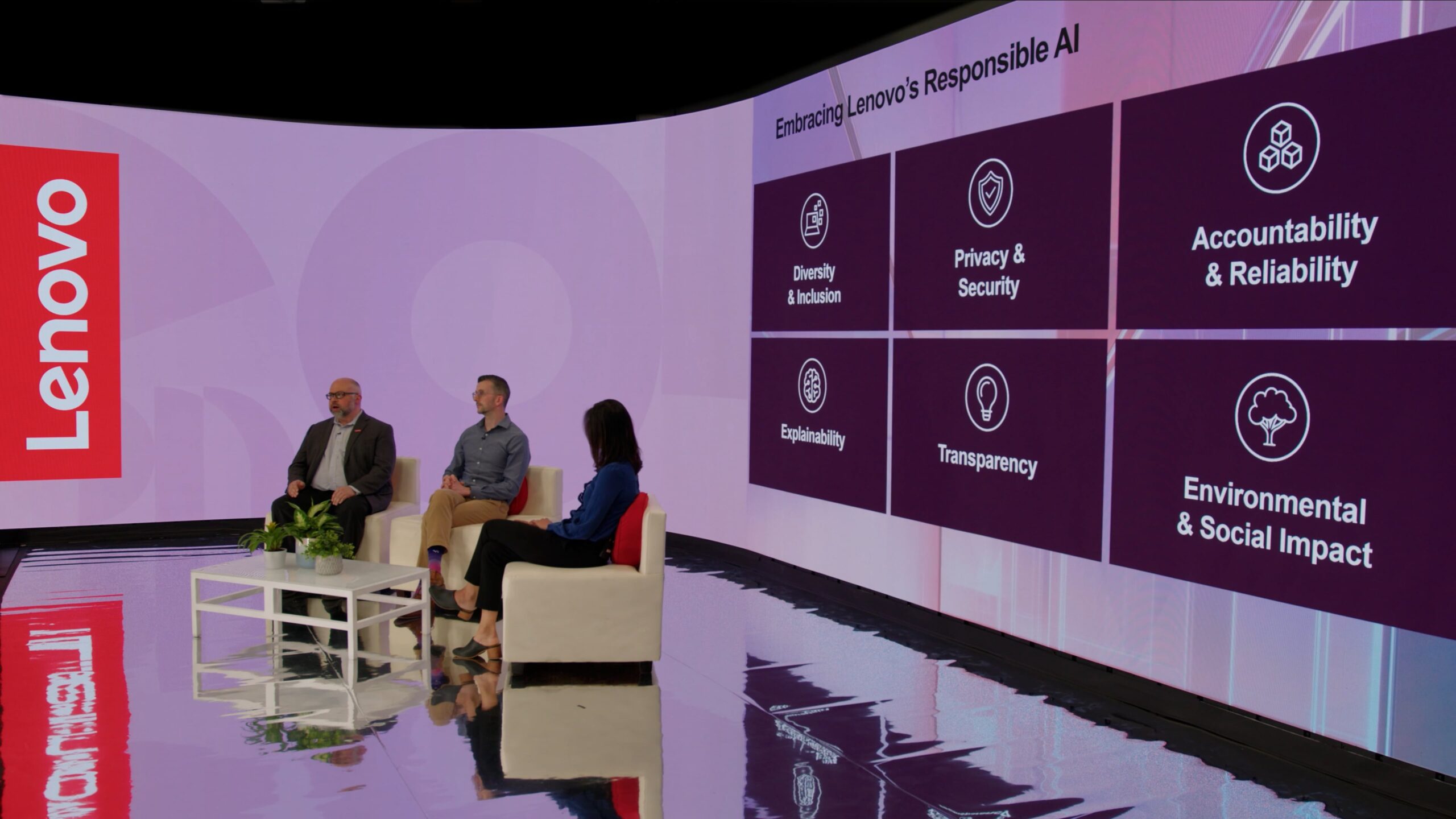 Panel discussion at TSEC Studio in Apex, NC, with three speakers seated in white armchairs beside a Lenovo-branded backdrop, in front of a large LED curved video wall displaying "Embracing Lenovo's Responsible AI".