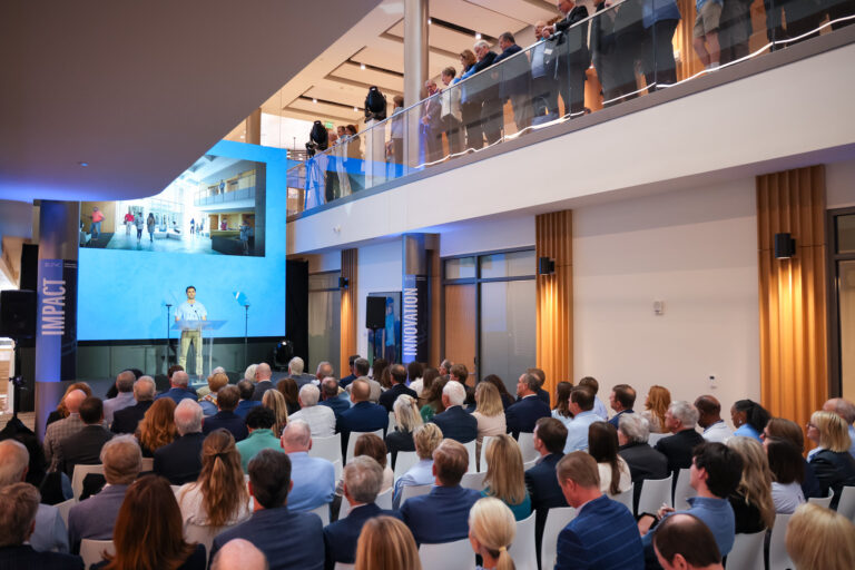 Student presenter on stage at the Steven D. Bell Hall Grand Opening Ceremony